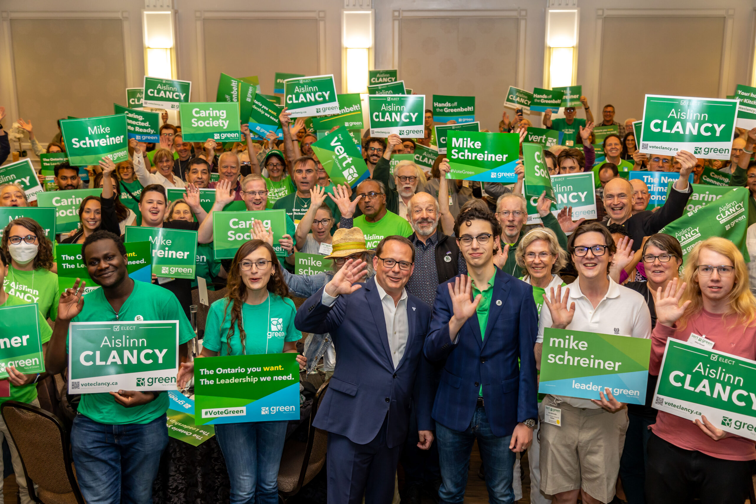 Mike Schreiner and  a excited group of green party supporters holding signs