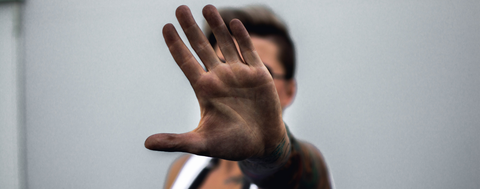 Woman holds her hand up. It's covered in soot from pollution