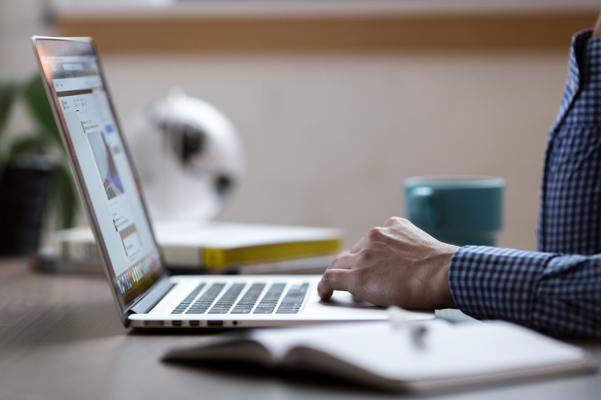 Man working with laptop and notebook