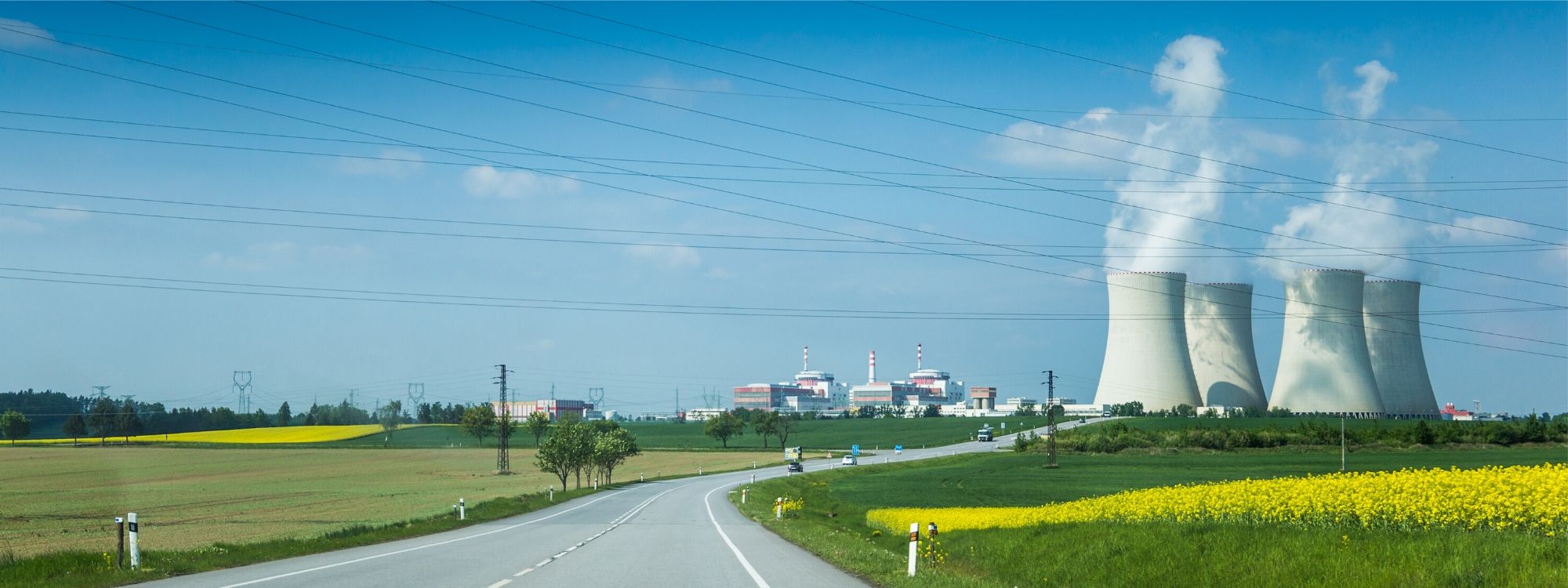 Nuclear power plant in green landscape with blue sky